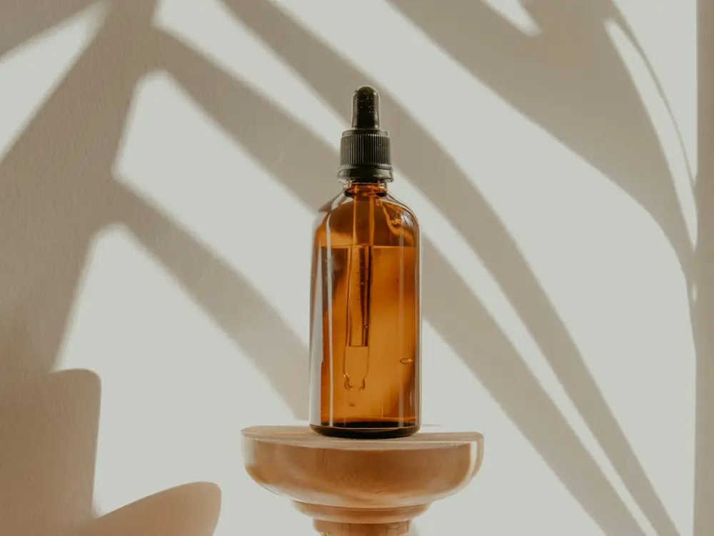 Amber glass dropper bottle in soft light