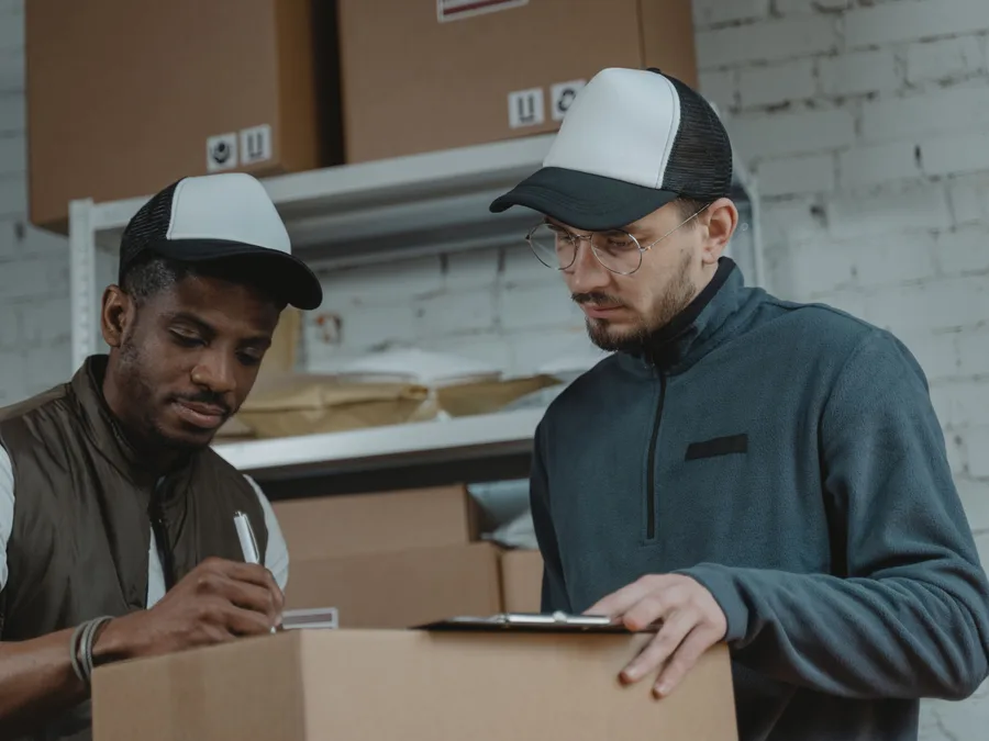 Worker checking off a bulk pallet load against a packing list