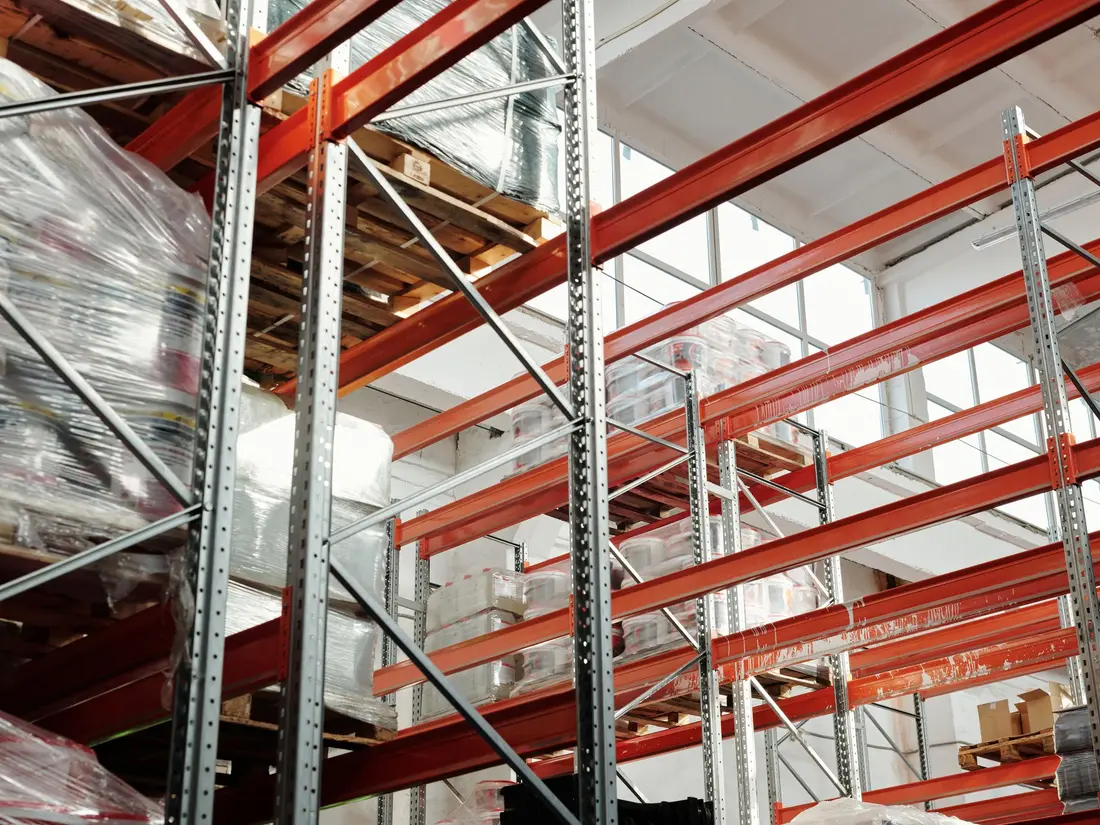Stretch-wrapped palletised stock stored in warehouse racking
